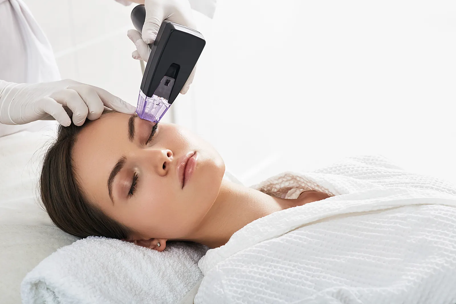 Microneedling handpiece in use during a treatment